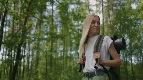Slow-motion-:-Portrait-Adult-woman-wearing-shorts-and-t-shirt-hikes-through-woods.-Young-lady-hiking